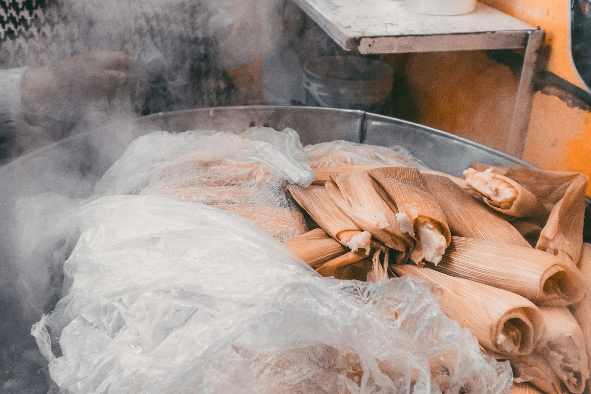 Tamales steaming in a pot